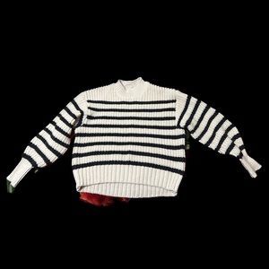 Soft, knit sweater with dropped shoulders, long sleeves, ribbing at neckline.